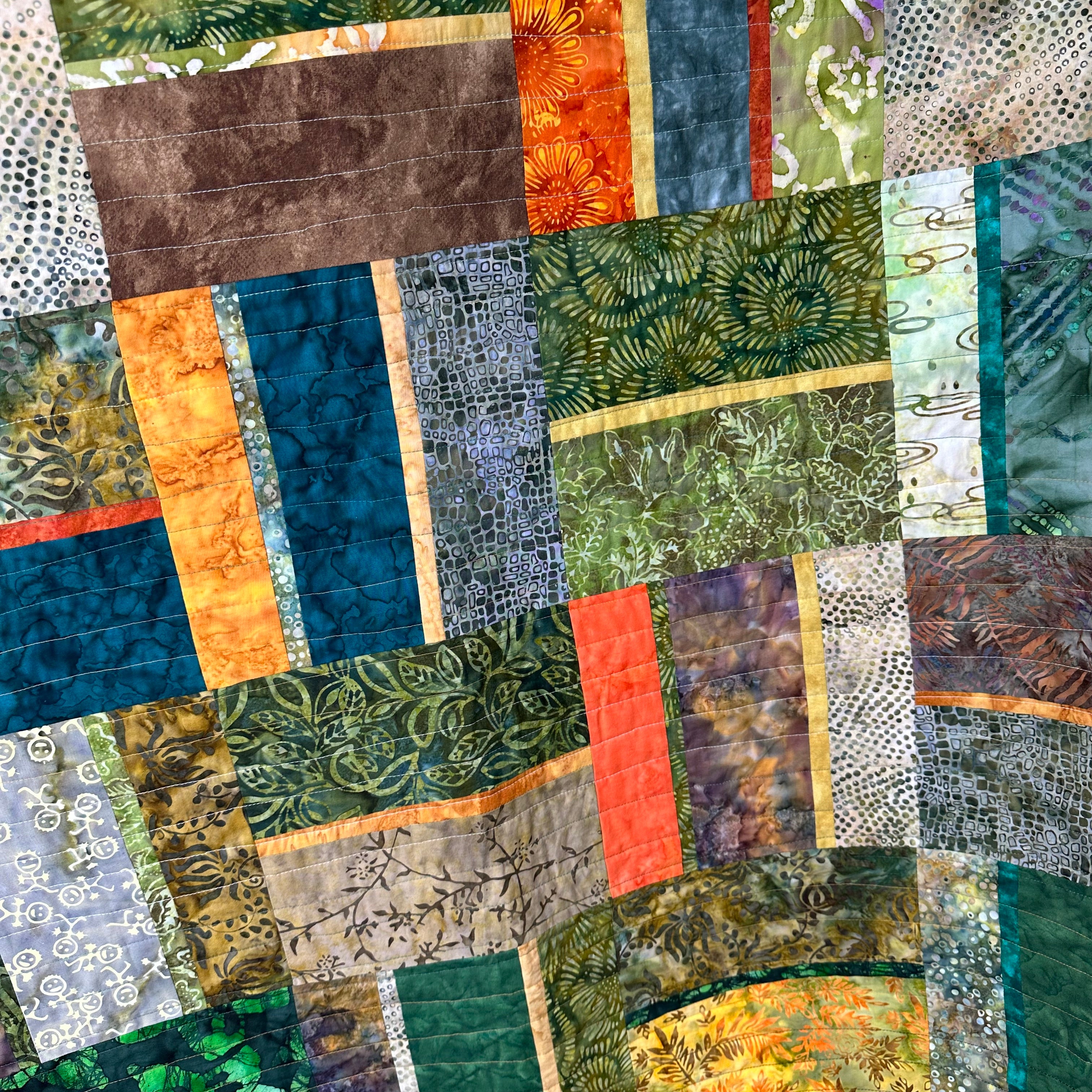 Quilted fabrics in greens and blues