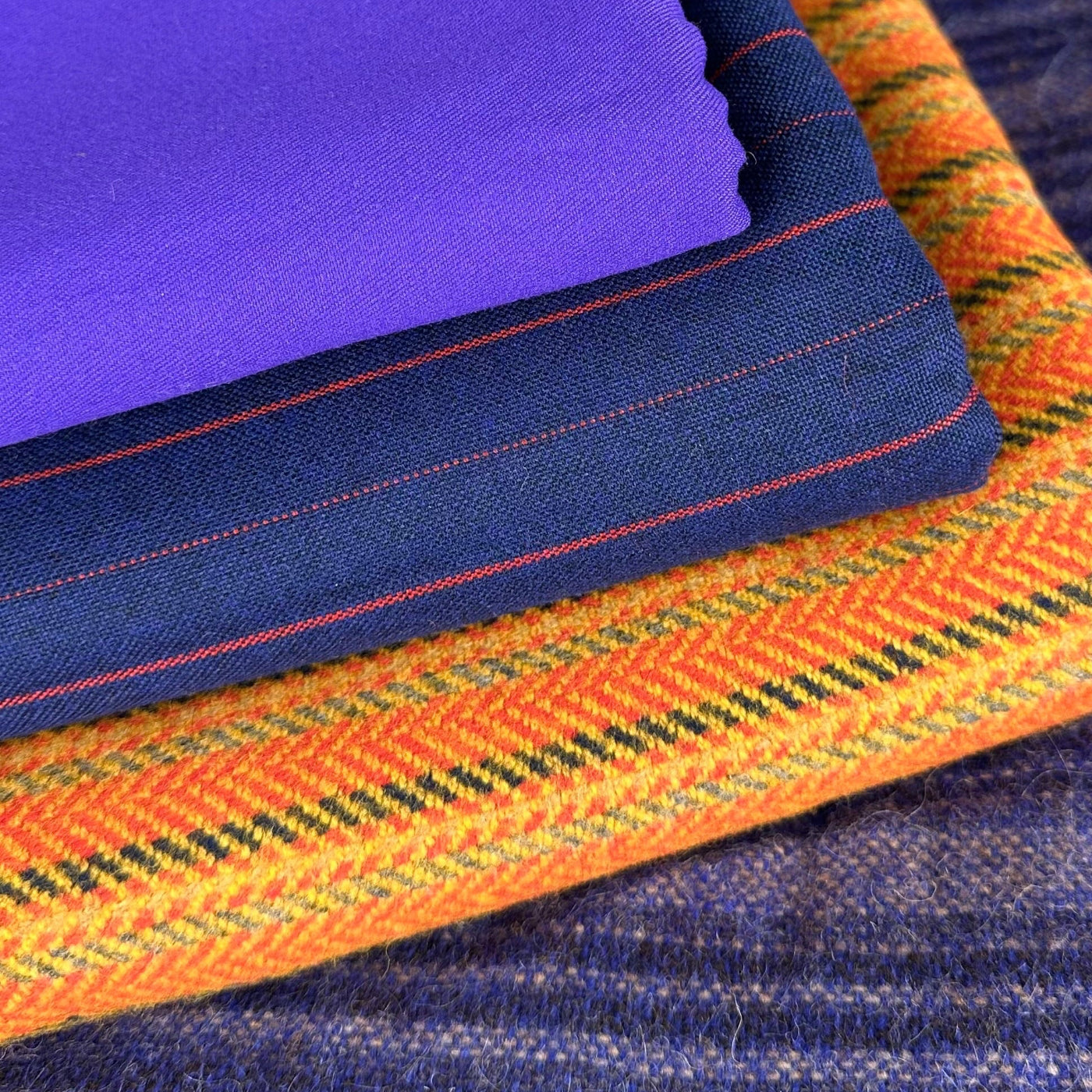 Close-up of blue, orange, and purple fabric with intricate patterns.